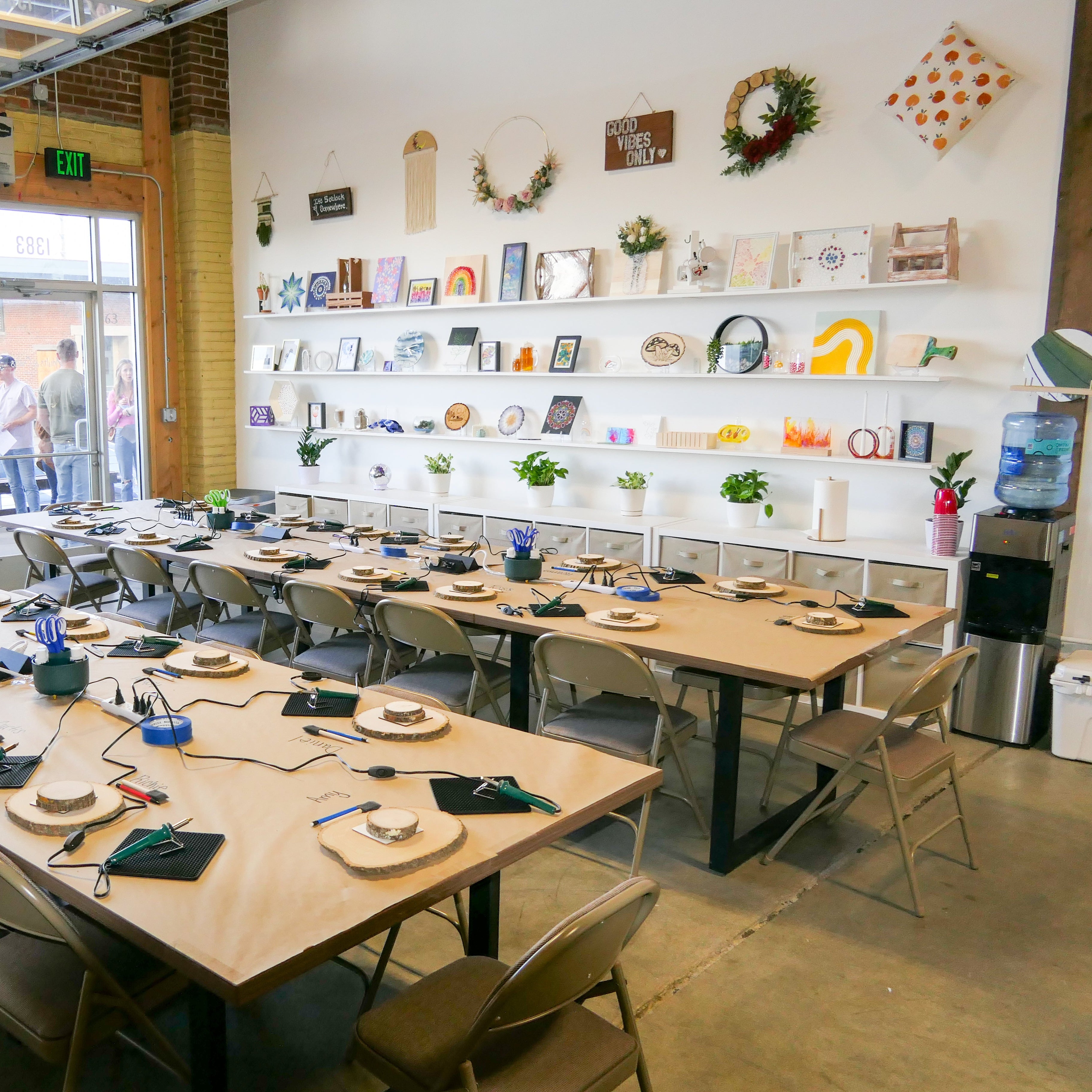 Large room with long wooden tables and chairs, set up for a meeting or event.